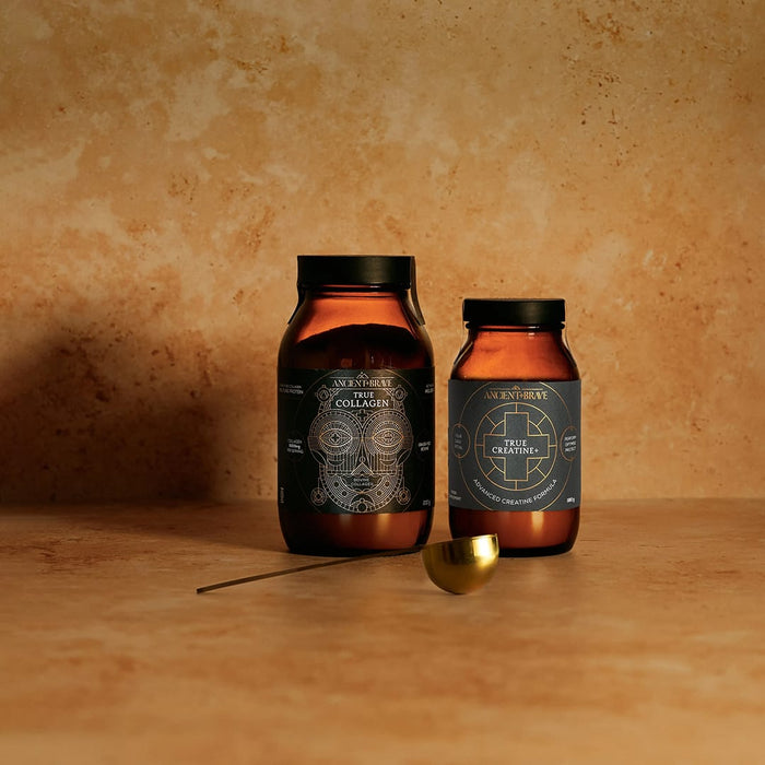 Two jars of True Collagen and True Creatine on a wooden surface with a warm background