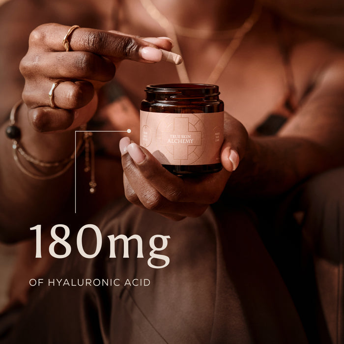 Person holding a jar of True Skin Alchemy with 180mg of hyaluronic acid