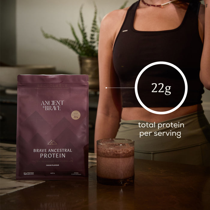 Protein package with a person wearing athletic wear, indicating 22g of protein per serving of Brave Ancestral Protein powder.