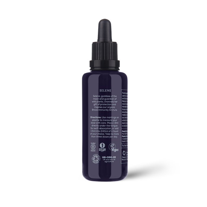 A dark blue dropper bottle labeled Brave Immunity by Ancient + Brave, featuring white text with product and usage details. The bottle has a black dropper cap, showcases several certification icons at the bottom, and emphasizes its blend of organic botanicals and functional mushrooms formulated to help strengthen immunity.