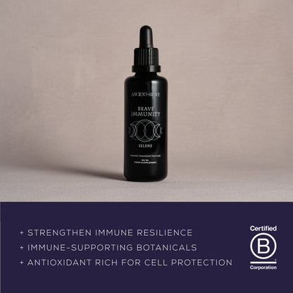 A black dropper bottle labeled Brave Immunity by Ancient + Brave rests on a light surface. The text highlights immune support, organic botanicals, functional mushrooms, antioxidants, and features a Certified B Corporation logo—all indicating ingredients crafted to help strengthen immunity.