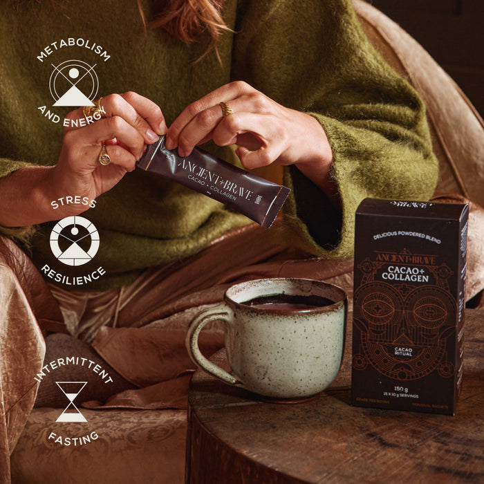 A woman in cozy clothing opens a sachet from the Ancient + Brave 10 x Cacao + Collagen Sachets, made with rich South American cacao and hydrolysed bovine collagen, beside a mug and product box. Icons highlight benefits for metabolism, stress resilience, and intermittent fasting.