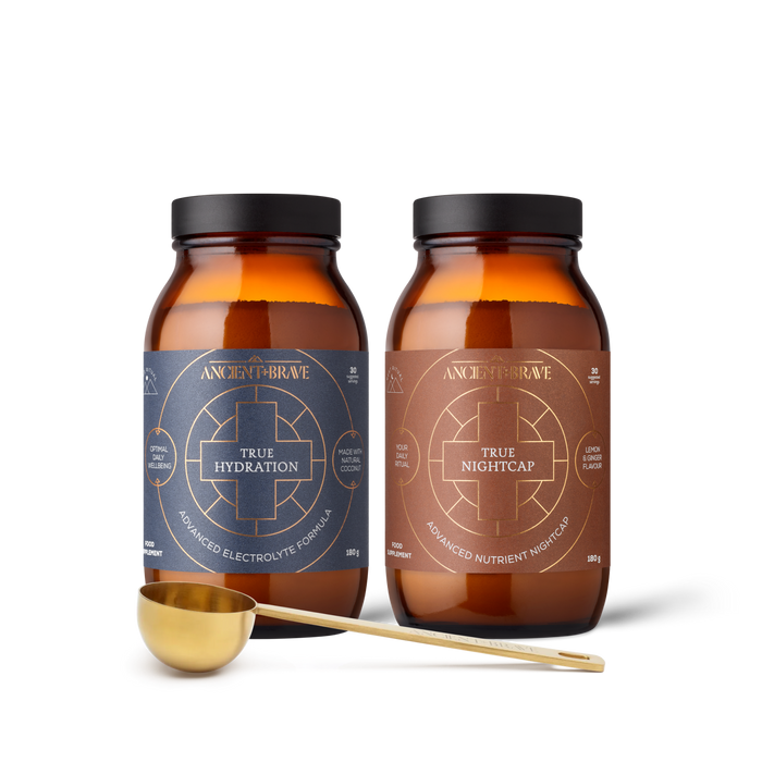 Two bottles of Ancient + Brave supplements with a gold scoop on a white background
