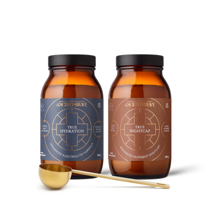Two bottles of Ancient + Brave supplements with a gold scoop on a white background