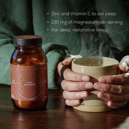 A person holds a steaming mug beside a jar labeled Dawn To Dusk Duo by Ancient + Brave. Text lists benefits: Zinc and Vitamin C to aid sleep, 130 mg of magnesium per serving, support for deep, restorative sleep, and added rehydration to help you wake up refreshed with True Hydration.
