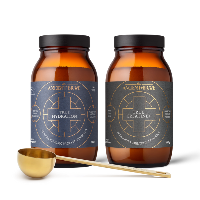 Two bottles of Ancient & Brave supplements with a measuring spoon on a white background