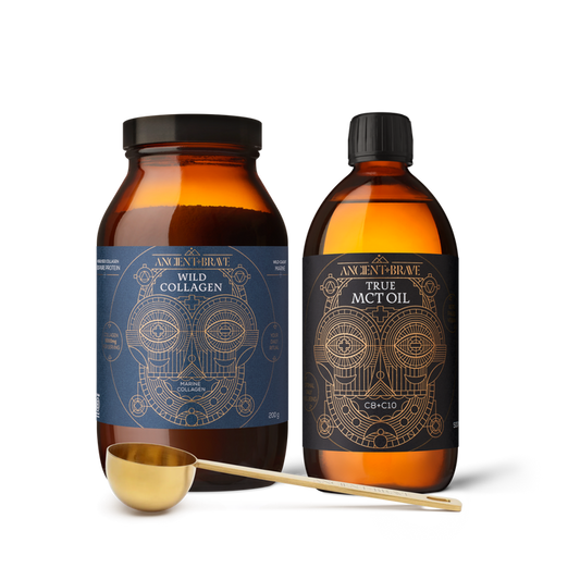 Two bottles of 'Ancient + Brave' Wild Collagen and True MCT Oil with a gold scoop on a white background.