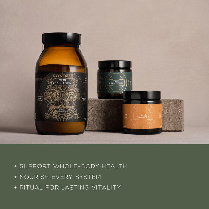 Three supplement jars from Ancient + Brave’s The Foundation Kit are displayed on stone blocks with a green overlay beneath listing their benefits: Support whole-body health, nourish every system, and provide a ritual for lasting vitality. This core trio—Collagen (featuring collagen peptides), Magnesium, and Omega—is formulated to deliver essential nutrients such as omega fatty acids for comprehensive wellness.