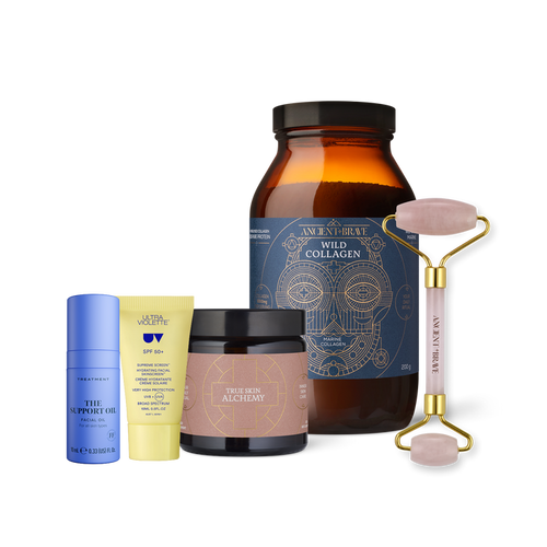 Four skincare products from Ancient + Brave’s The Skin Essentials Kit, along with a pink facial roller, are displayed on a white background. The set features an amber collagen jar, a small yellow tube for daily SPF protection, a purple oil bottle, and a tan skincare jar—all expertly designed to help you achieve radiant-looking skin.