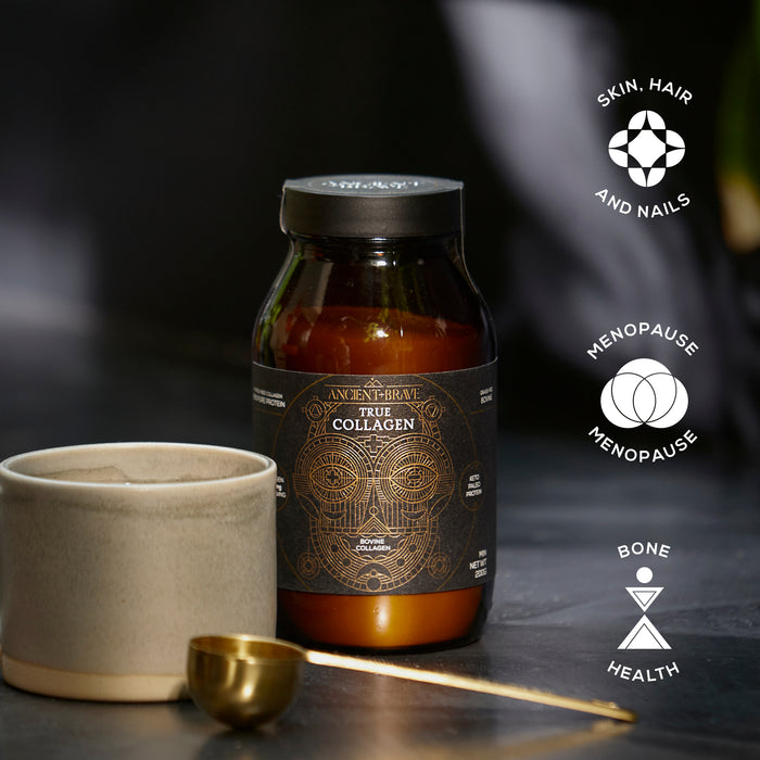 A dark glass jar labeled Ancient + Brave True Collagen, featuring hydrolysed bovine collagen, sits beside a ceramic cup and gold spoon. Three icons highlight benefits: skin, hair and nails; menopause support; and bone health.