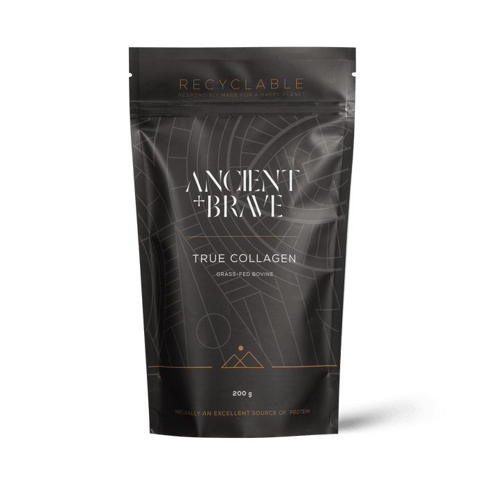 A premium black and gold pouch labeled “Ancient + Brave True Collagen” contains 200g of Type I hydrolysed bovine collagen peptides, sourced from grass-fed cattle. The packaging features geometric patterns, displays both protein content and recyclability, positioning True Collagen as a standout among supplements from Ancient + Brave.