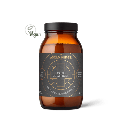 A brown glass jar labeled Ancient + Brave True Creatine+ with a black and gold label, supporting muscle health, sits next to a green Vegan logo on a white background.