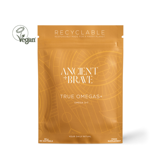 Ancient + Brave True Omegas+ food supplement in a recyclable orange stand-up pouch, shown on a white background with a Vegan logo overlay.