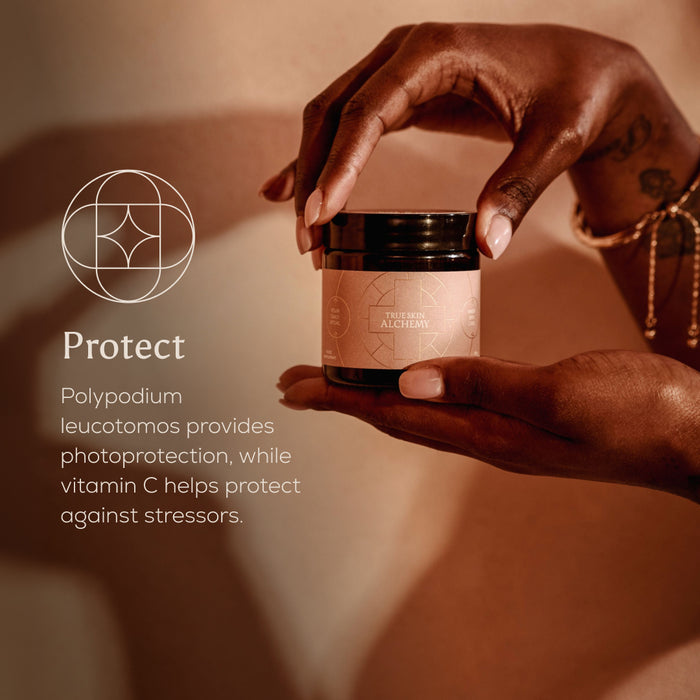 Hand holding a skincare jar with text about photoprotection and vitamin C benefits.